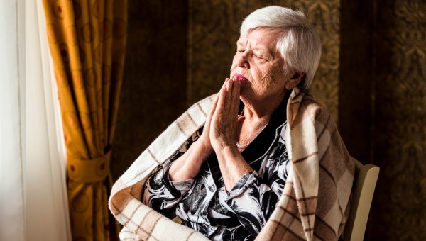 OLDER WOMAN PRAYING