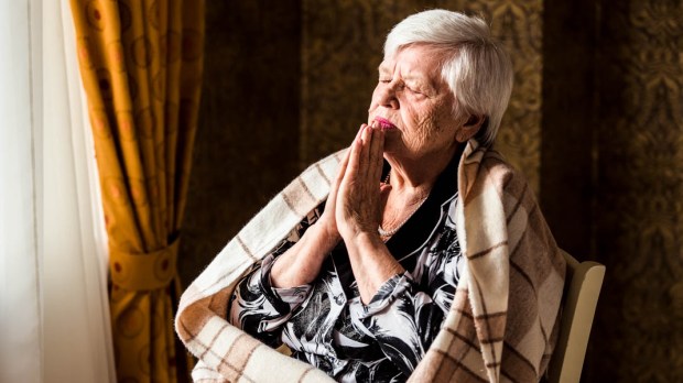 OLDER WOMAN PRAYING