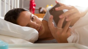 WOMAN,BED,PHONE