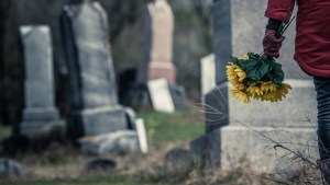 WOMAN,FLOWERS,CEMETERY