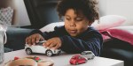 LITTLE BOY PLAYING WITH CARS