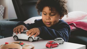 LITTLE BOY PLAYING WITH CARS