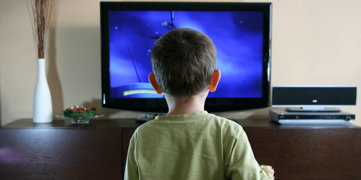 KID IN FRONT OF A TV