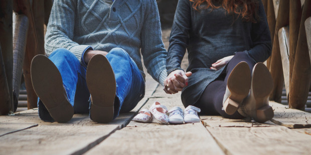 COUPLE SITTING,HOLDING HANDS