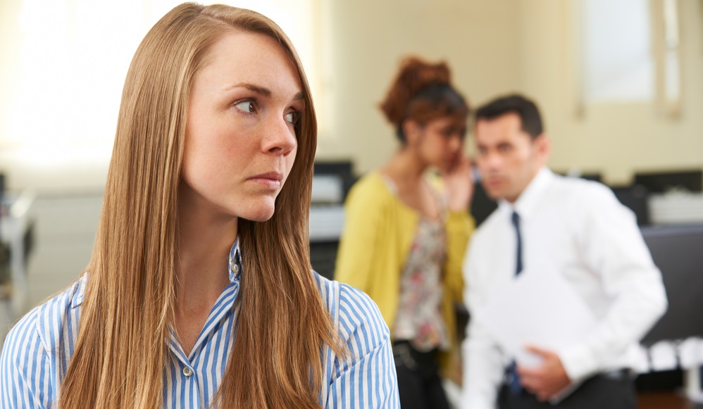 woman Being Gossiped About By Colleagues