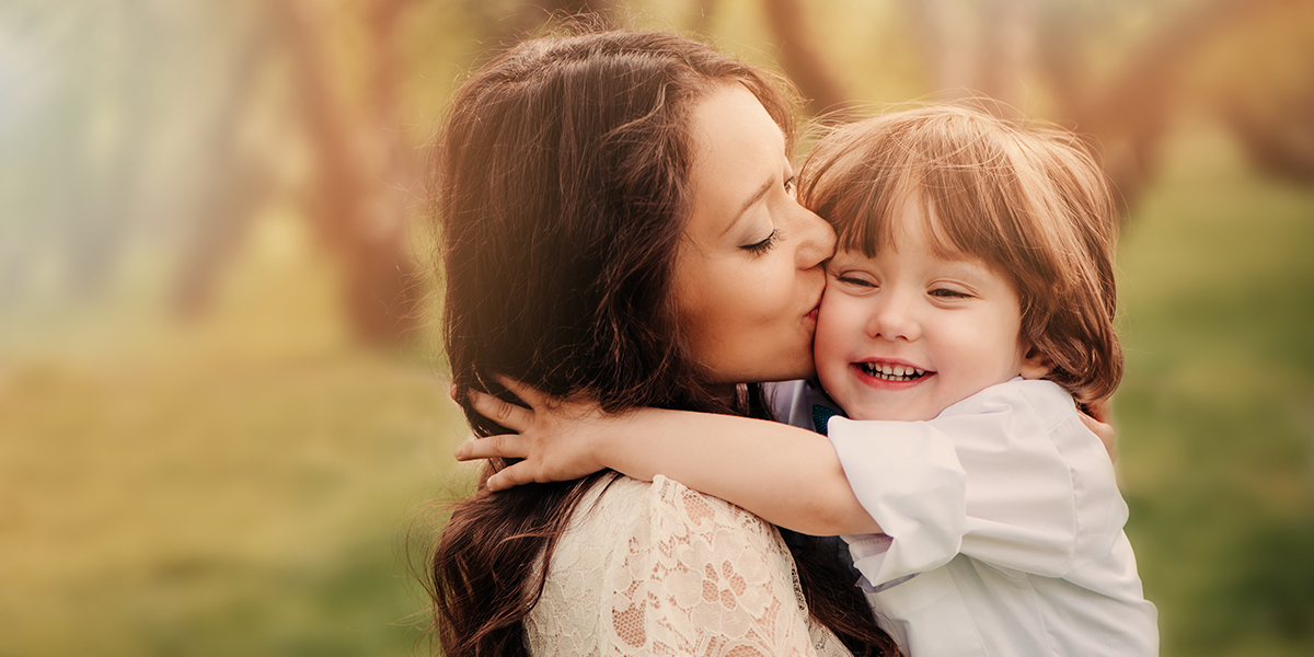 web3-happy-loving-young-mother-kisses-her-toddler-son-on-the-walk-shutterstock_317881043.jpg