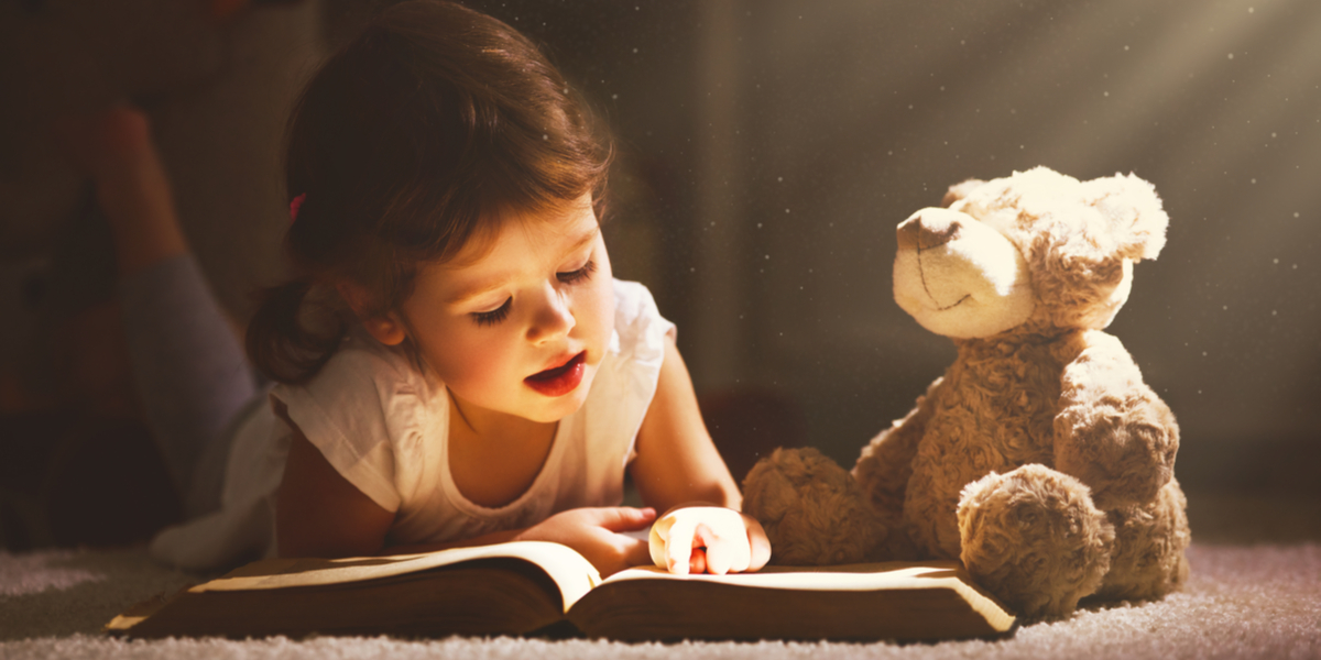 LITTLE GIRL READING A BOOK