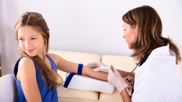 web2-side-view-of-female-doctor-taking-blood-sample-of-an-afraid-child-patient-in-clinic-shutterstock_1282475875.jpg