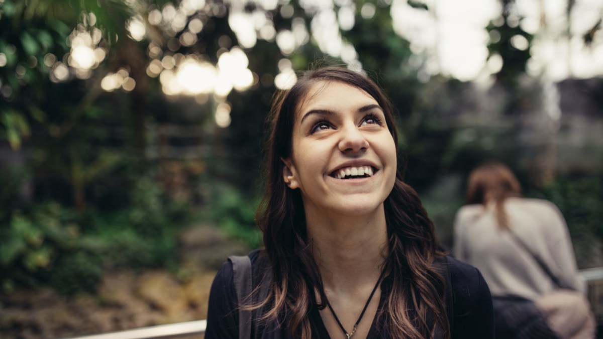 excited woman looking up smiling