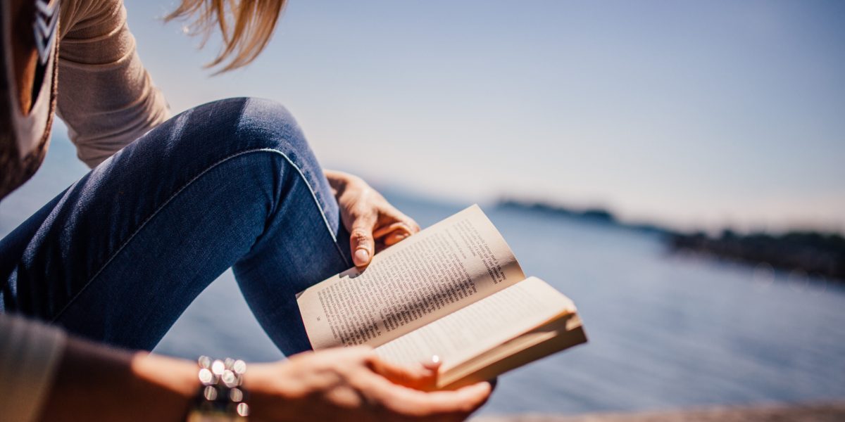 WOMAN, READING, SEA