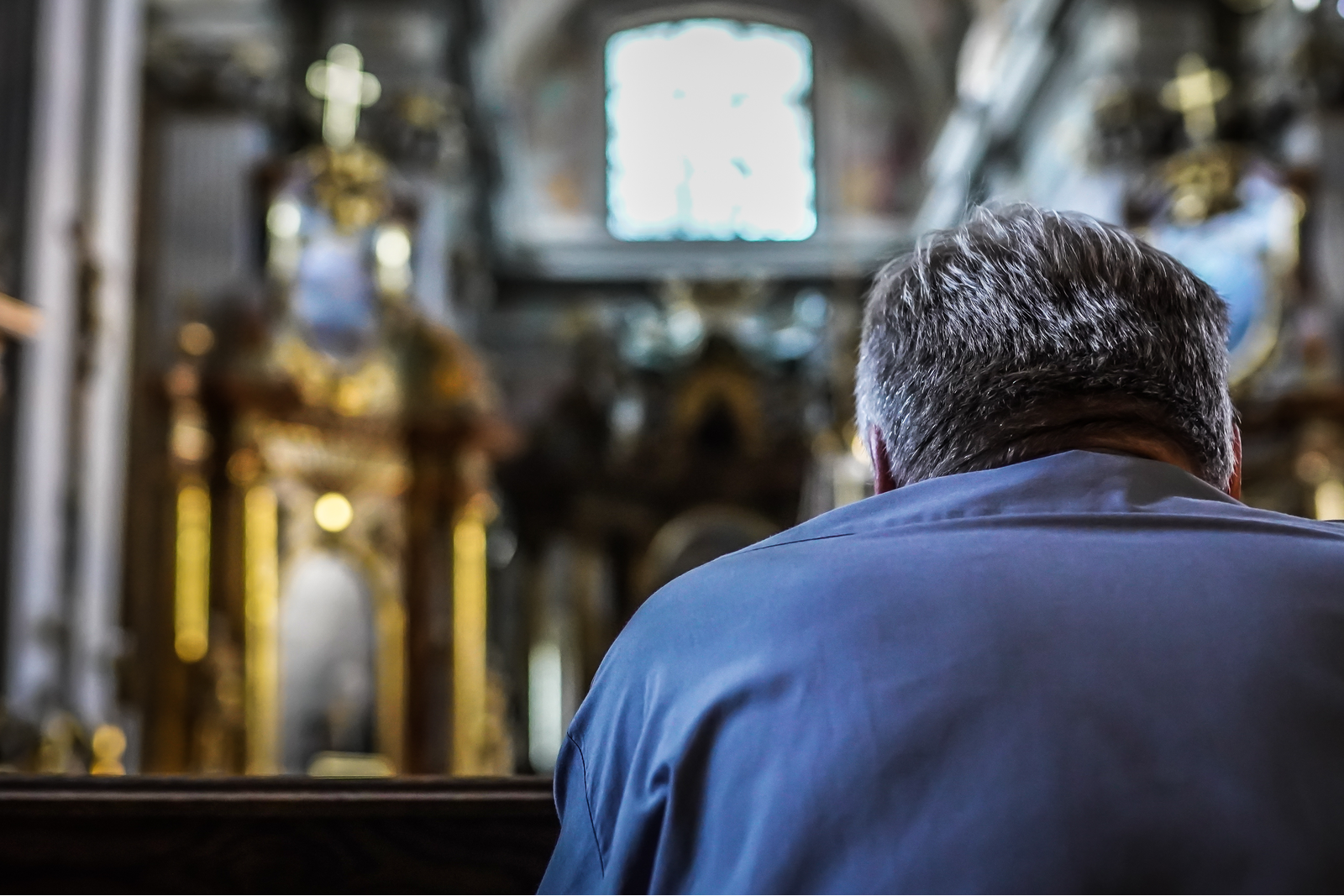 man praying in a church