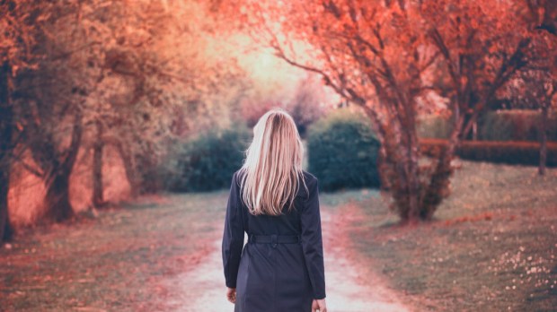 woman walks in the park in autumn