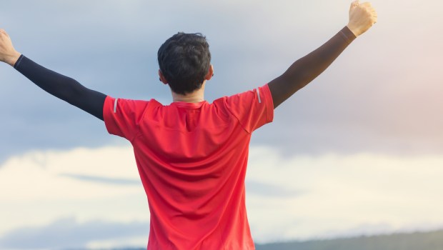 young man, arms to the sky,