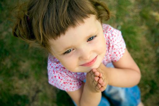 pretty young girl praying with her hands held together – ar