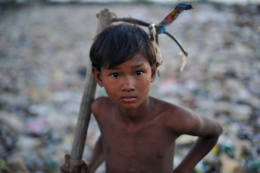 a Myanmar boy holding a tool – ar