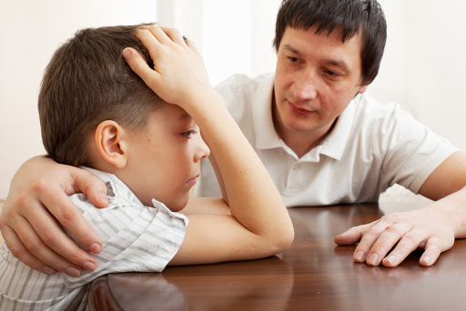 Father comforts a sad child. Problems in the family – ar
