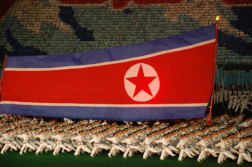 Military demonstration with flag in North Korea