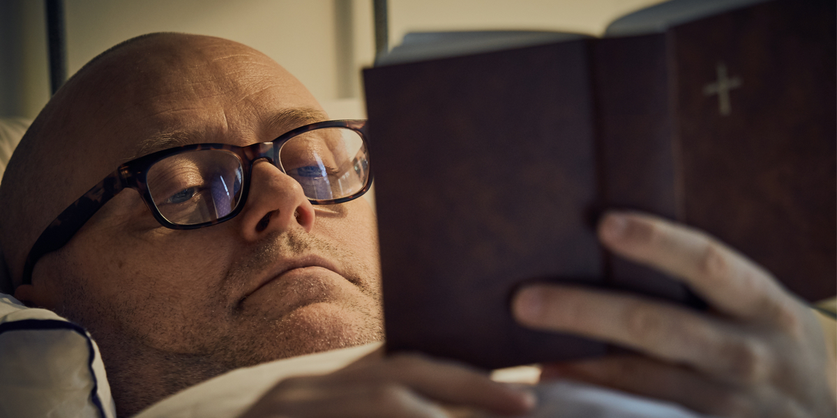 web3-middle-aged-man-reading-bible-on-bed-shutterstock_587738669.jpg