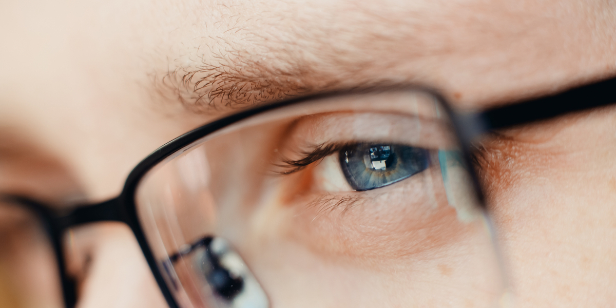 WEB3-Close-up-of-glasses-and-blue-eye-of-man-Concept-businessman-student-read-reflect-think-Shutterstock_1027636945.jpg