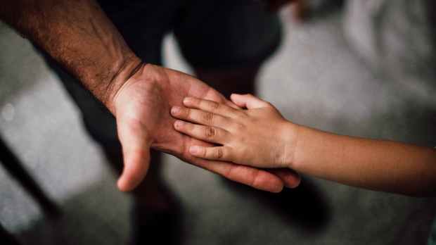 selective focus photography of child s hand