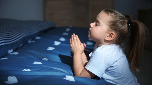 LITTLE GIRL PRAYING IN BED,