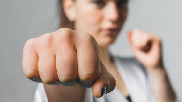 WOMAN PRACTICES KARATE,