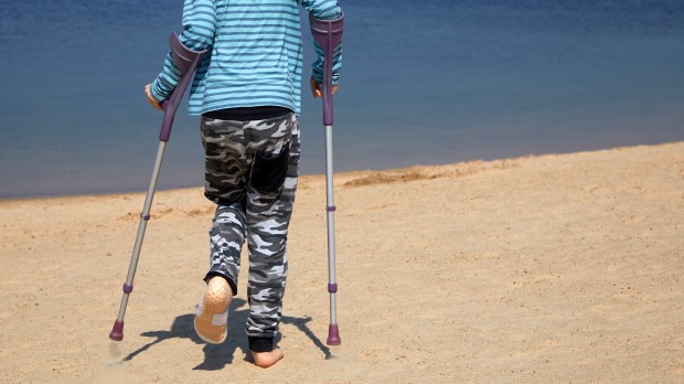 BOY, CRUTCHES, SEA