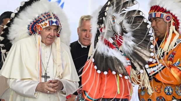 Pope-Francis-wears-a-headdress-Indigenous-leaders-at-Muskwa-Park-in-Maskwacis-Canada-AFP
