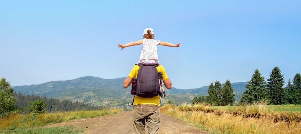 Man with a children walking on a way