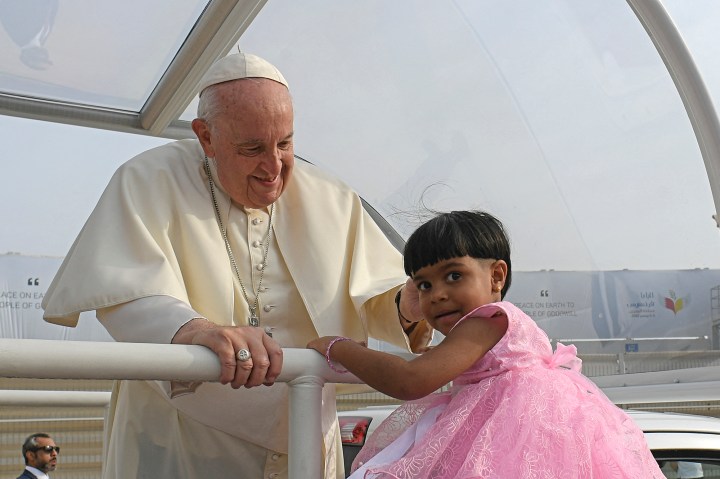 Pope-Francis-blessing-a-child-as-he-arrives-to-celebrate-mass-at-Bahrain-National-Stadium-in-Riffa-AFP