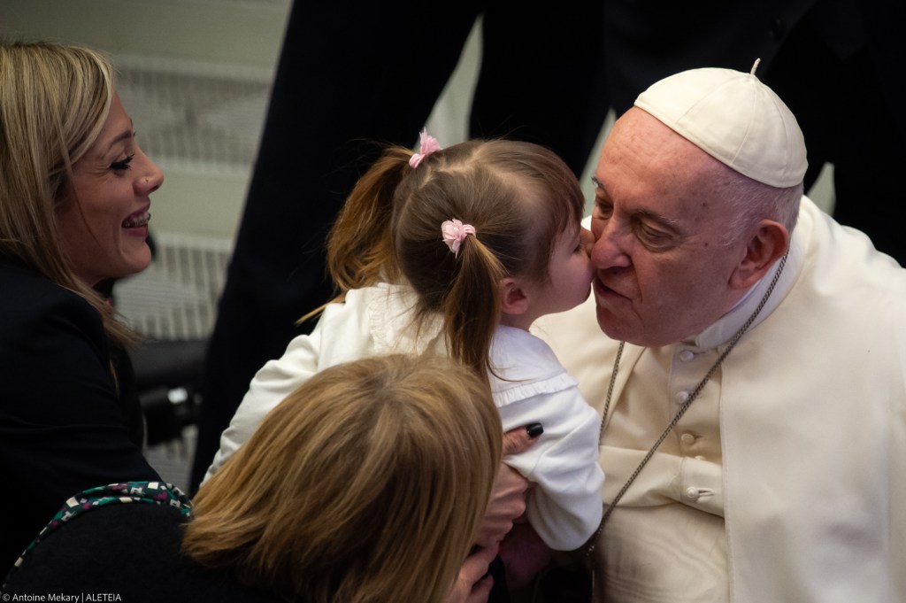 A little girl kisses Pope Francis
