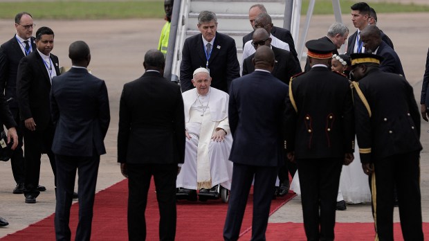 Pope-Francis-seated-on-a-wheelchair-waves-as-he-arrives-at-the-Ndjili-International-Airport-in-Kinshasa-AFP