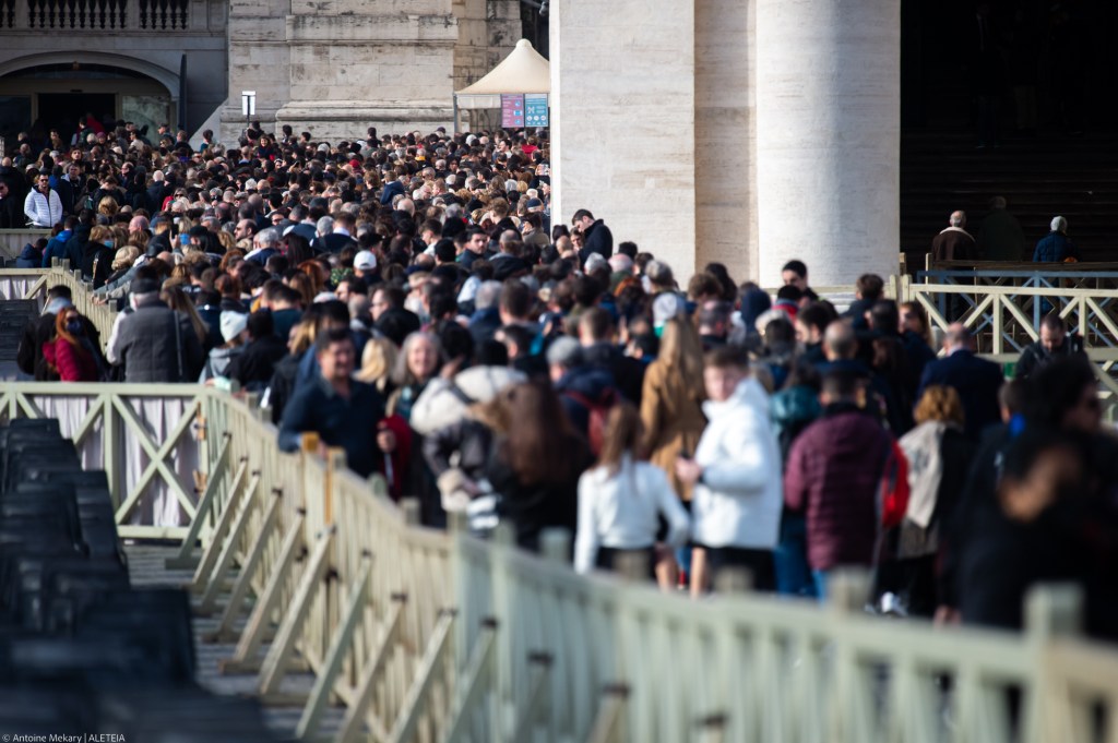People queuing to visit Saint Peter's Basilica where the body of the blessed emeritus pope is located.