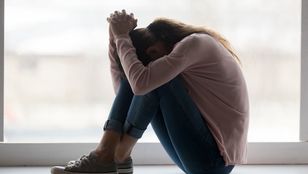 Depressed sad teen girl sit on sill crying alone at home upset desperate young woman feeling frustrated anxious regret mistake suffer from unwanted teenage pregnancy abortion problem concept