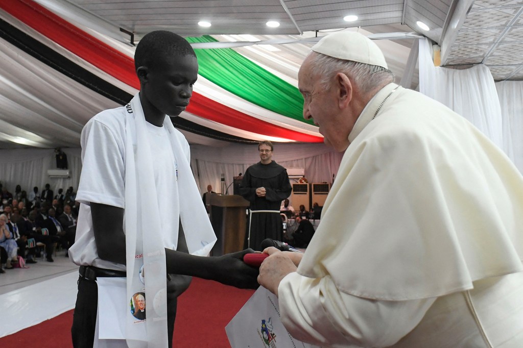 Pope Francis receiving a gift during a meeting with internally displaced persons at the Freedom Hall in Juba South Sudan