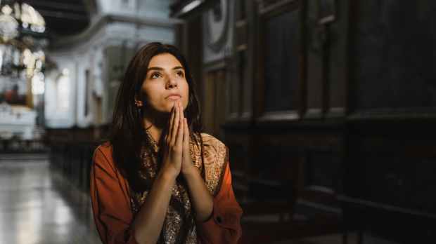 a woman praying inside the church