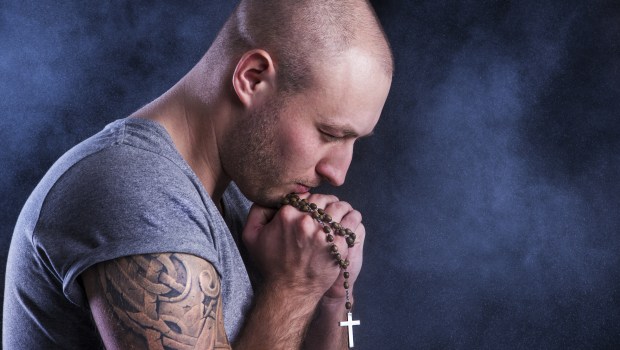 Man with tattoo and rosary