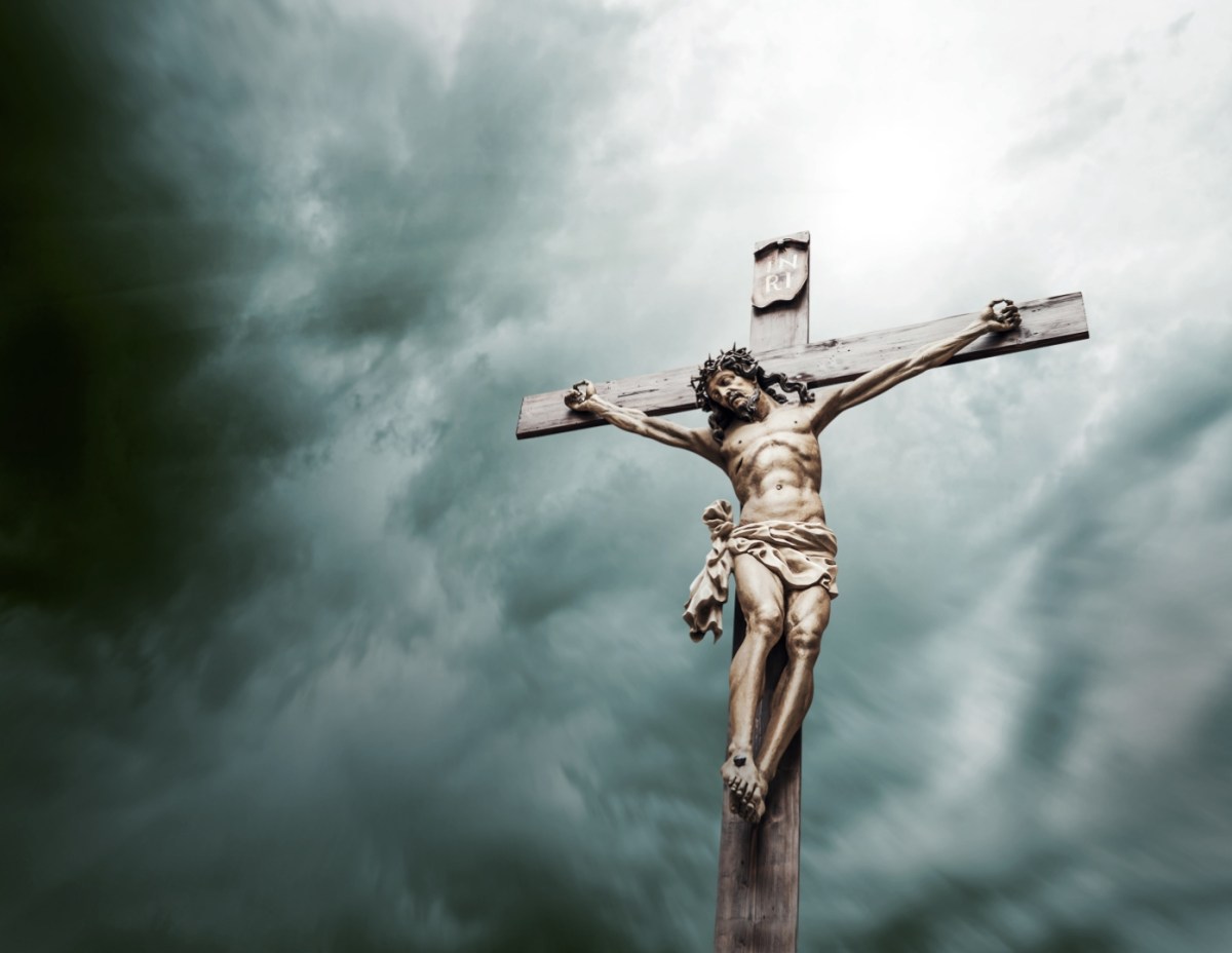 Jezus Chrystus na krzyżu na tle zachmurzonego nieba