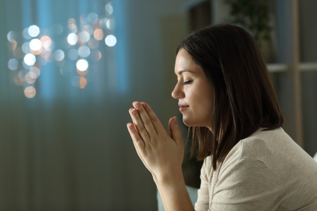 PRAY-WOMAN-CHURCH-shutterstock_1822640993.jpg