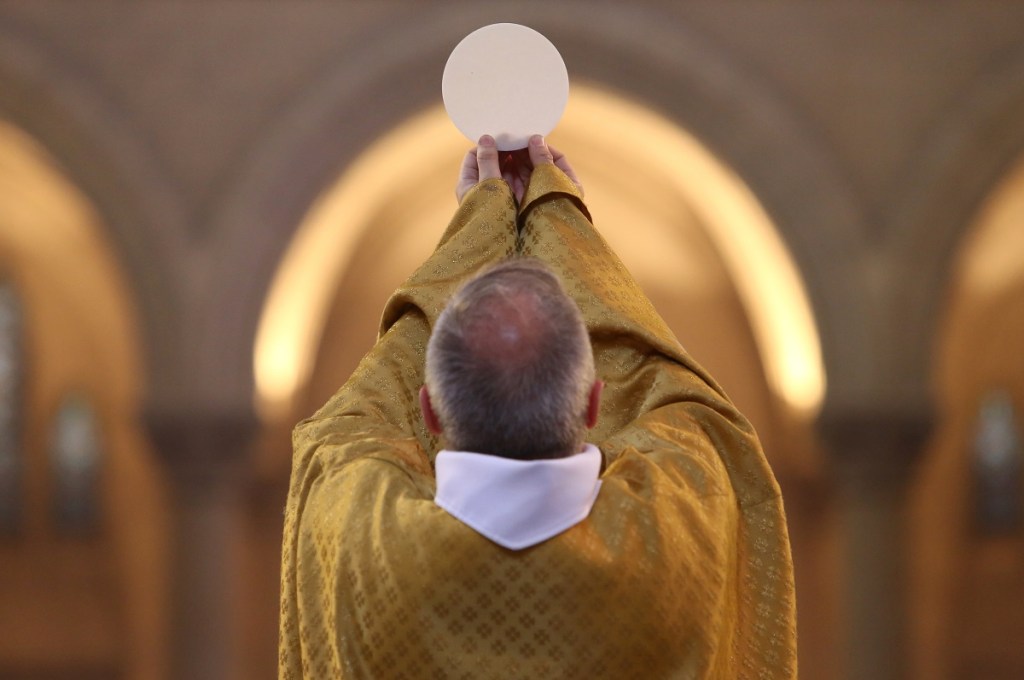 Priest raising Eucharist