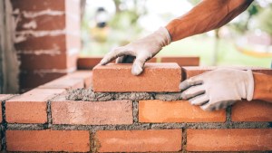 professional construction worker laying bricks