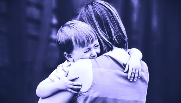 Child crying on mom's shoulder