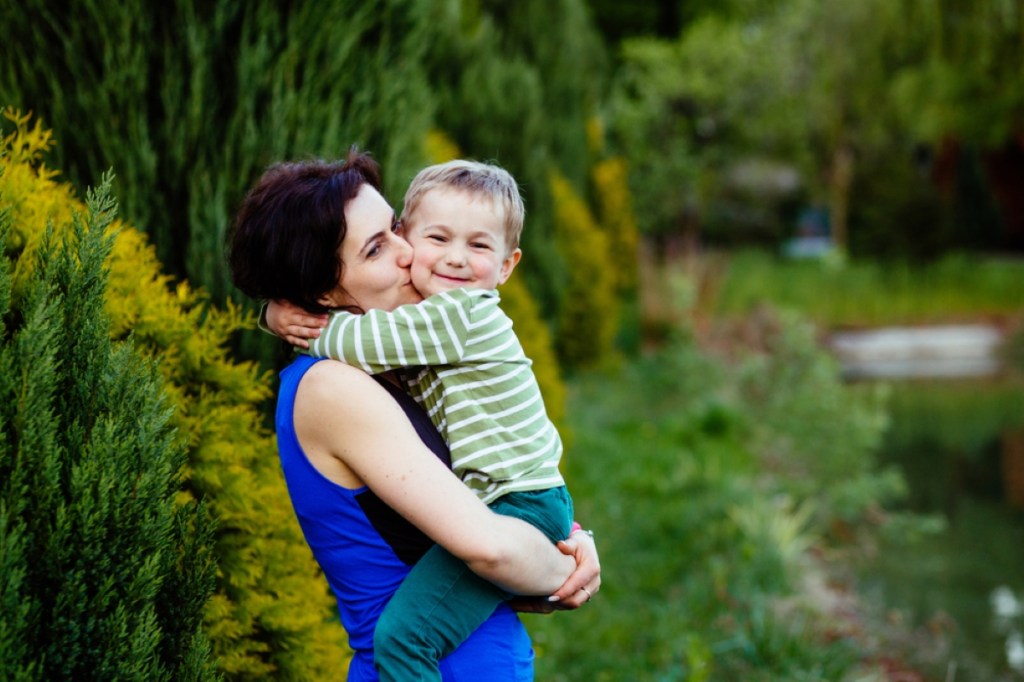 Happy family mother and toddler baby boy with sweet emotion hugging