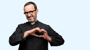 Priest religion man happy showing love with hands in heart