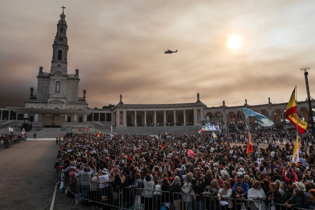An helicopter of the Portuguese Airforce carrying Pope Francis flies over the Shrine of Our Lady of Fatima