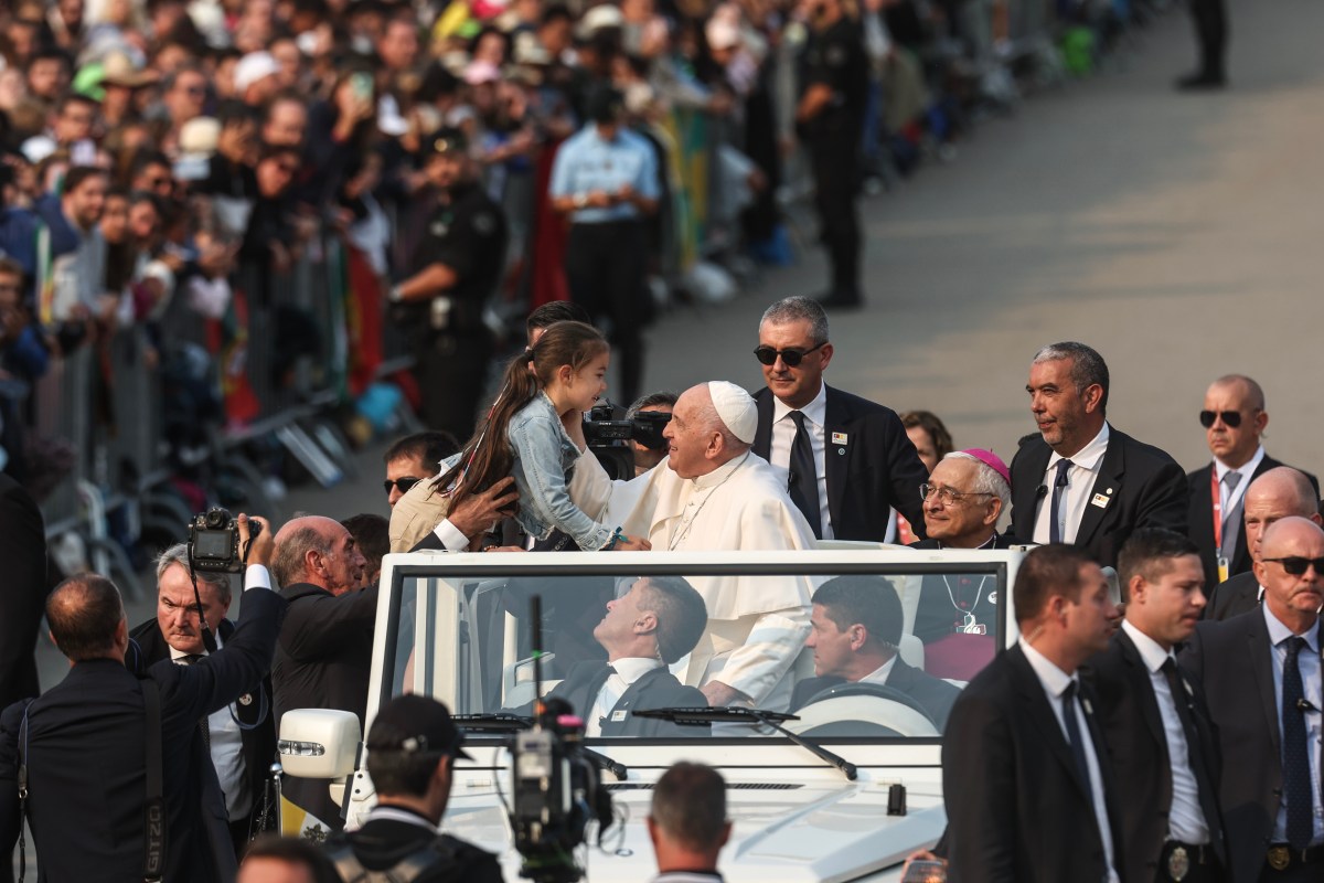 Pope Francis blesses a child at Shrine of Our Lady of Fatima, in Fatima, Ourem, Portuga