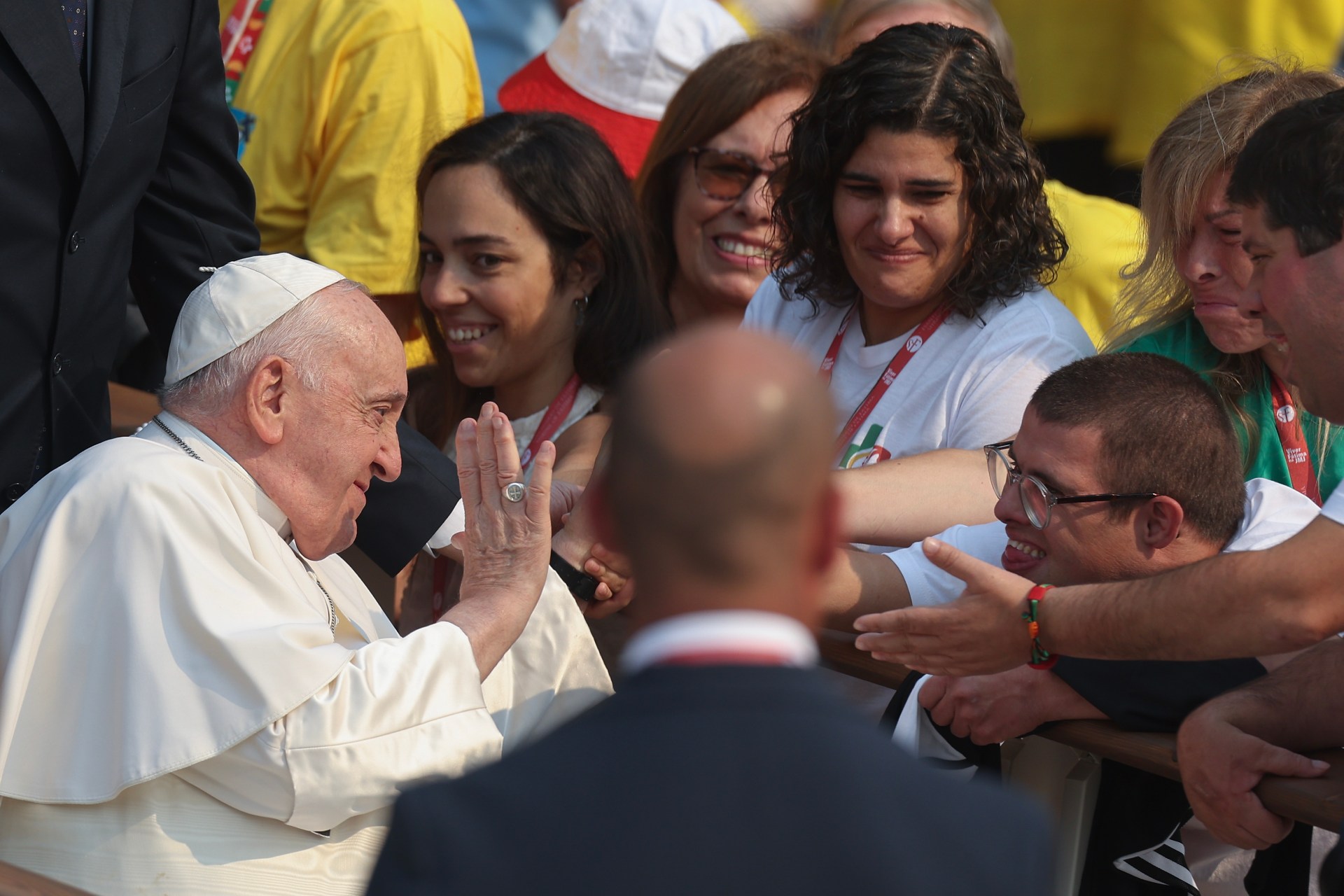 Pope Francis touches a pilgrim at the Shrine of Our Lady of Fatima, in Fatima, Ourem,