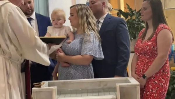 Criança sendo batizada