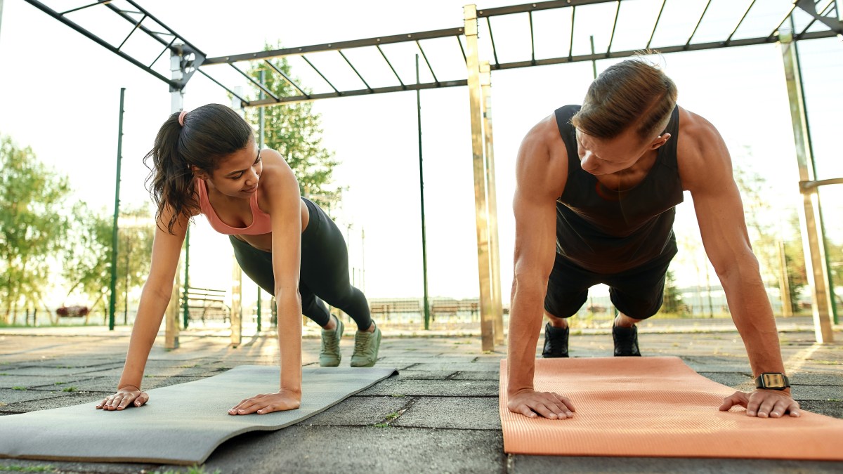 Parejas-de-deportistas-de-raza-mixta-haciendo-ejercicio-en-el-parque-deportivo-Estilo-de-vida-saludable-y-concepto-d-shutterstock_1872972142