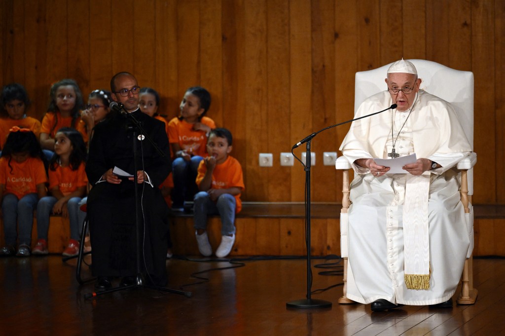 Pope Francis delivers a speech as he visits the Serafina parish